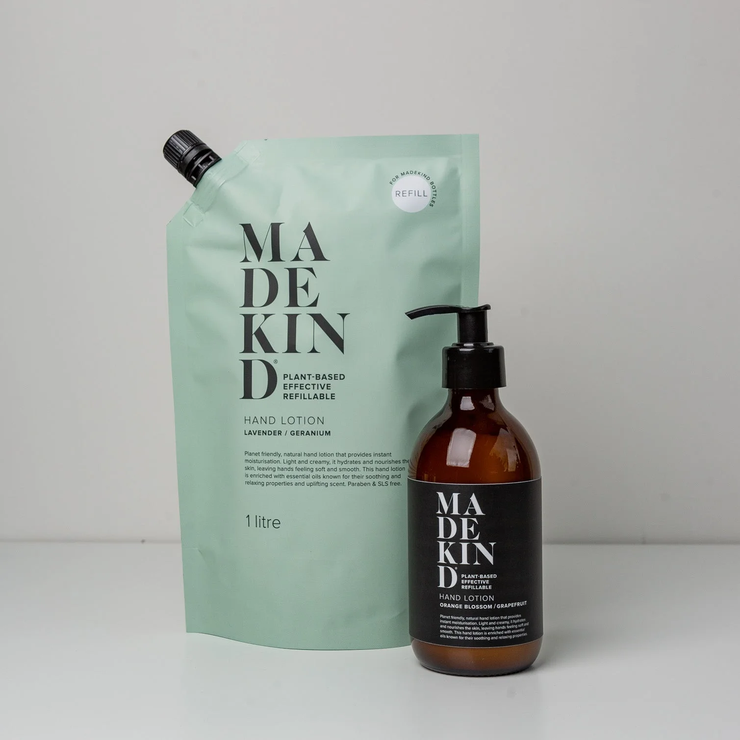 Photo of a MadeKind 1 Litre Hand Lotion Refill pouch and an empty glass bottle