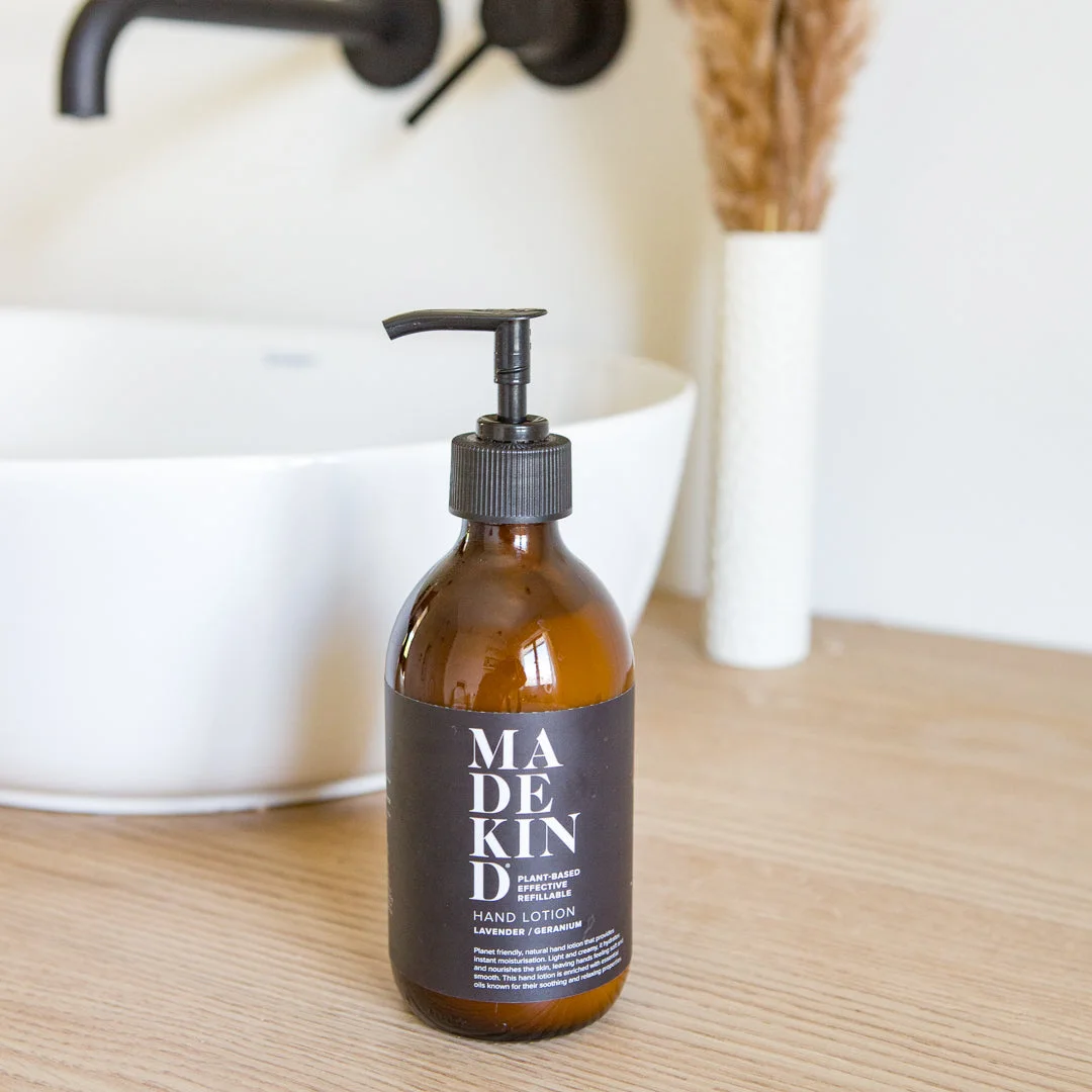 Natural hand lotion in amber glass bottle with lavender and geranium essential oils.