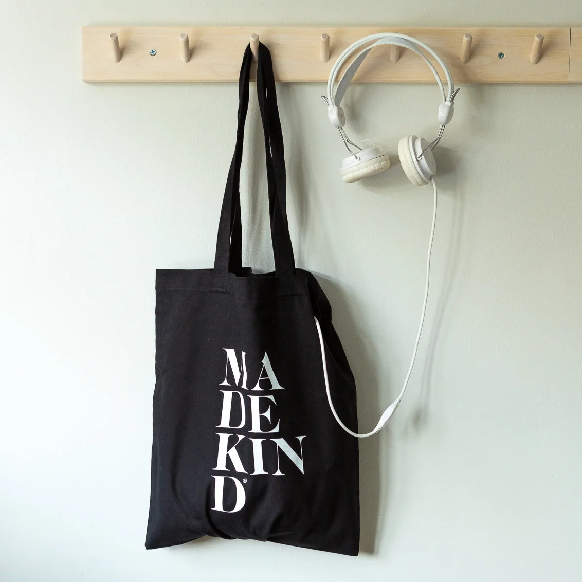 MadeKind black tote bag hanging on a peg